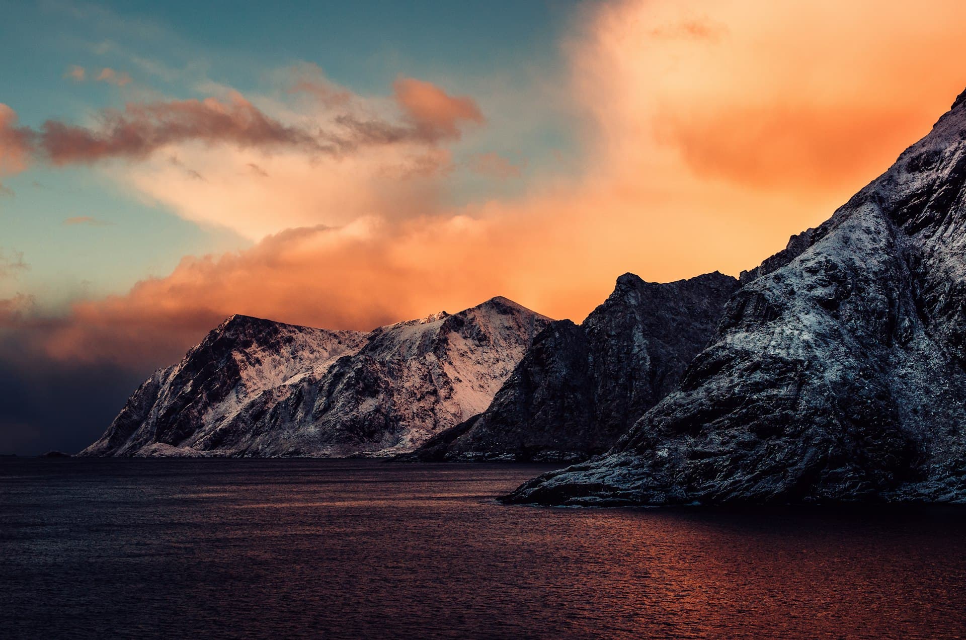 Snow covered mountain with sunset in the background